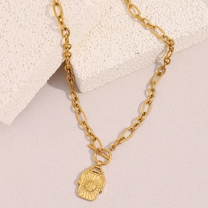 Detailed view of an 18K gold plated moon square pendant on a thick link chain necklace