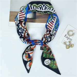 Detailed view of silk scarf with retro patterns and France Paris text on white background