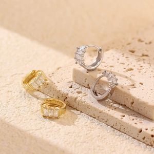 Detailed shot of gold and silver S925 sterling silver earrings with rectangular zircon