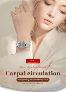 Close-up of gold steel band watch with crystal bezel and grey dial on model
