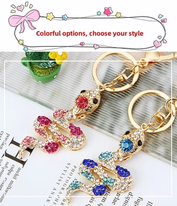 Macro shot of colorful rhinestone snake keychains with sparkling crystal details and gold alloy