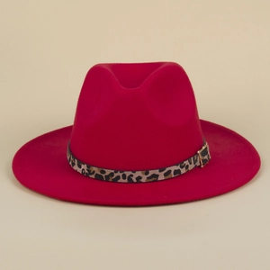 Detail of red wool fedora hat featuring a leopard print band and golden buckle