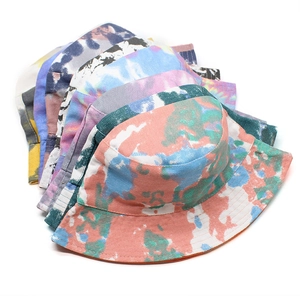 Detailed stack of colorful tie-dye bucket hats in various vibrant patterns and cotton fabric
