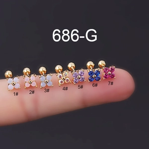 Macro view of seven colored flower stud earrings with opal and cubic zirconia on fingertips