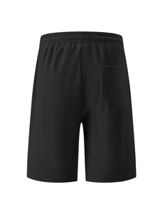 Rear view detail of black corduroy shorts showing elastic waistband and back pocket