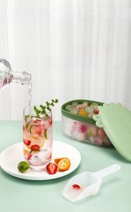 Detail of crocodile ice storage box with clear scoop and colorful fruit ice cubes