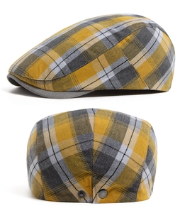 Detail of plaid beret hat showing tartan fabric texture and metallic back buckle