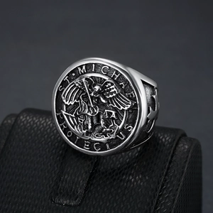 Detailed macro view of retro St. Michael protect us engraving on stainless steel ring