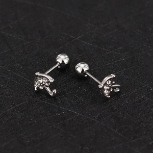 Detail shot of umbrella-shaped stud earrings with zircons and ball screw backs