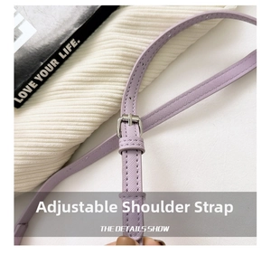 Close-up of adjustable purple cross-grain leather strap with silver buckle detail