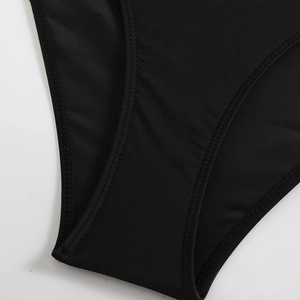 Detailed close-up showing professional double-needle stitching on black elastic swimsuit fabric