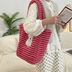 Detail of striped plush puppy tote bag showing soft sherpa texture and HAPPY embroidery