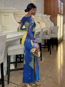 Detail of high-slit printed maxi skirt and crop top set with artistic blue yellow patterns