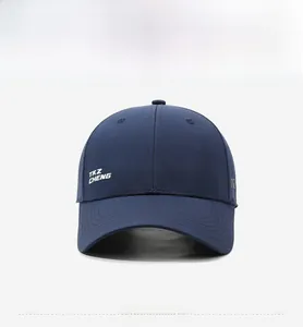 Detail of dark blue baseball cap featuring TKZ CHENG white printing and mesh fabric