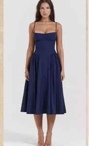 Detail of navy blue corset style midi dress with pleated A-line skirt and thin straps