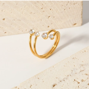 Detail of gold double-layer open ring featuring four brilliant-cut round cubic zirconia