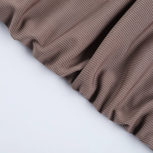 Detailed close-up of brown ribbed knit fabric showing soft texture and elastic material