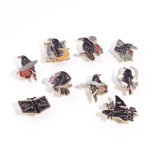 Gothic raven enamel pins set with mystical moon and rose designs on white background