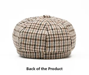Rear view of vintage houndstooth newsboy hat with textured fabric and top button
