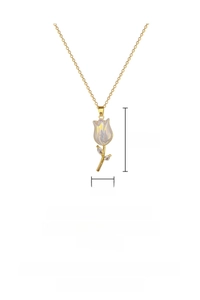 Macro detail of tulip pendant featuring iridescent mother of pearl and gold chain