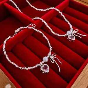 Silver bow bracelet and necklace set with pink heart stone and white pearl in velvet box