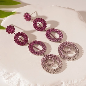 Detail view of tiered geometric round earrings with purple gradient crystal rhinestones
