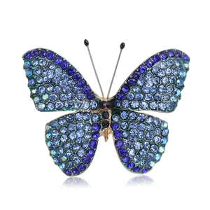 Elegant gold butterfly brooch with blue rhinestones and gradient crystal details