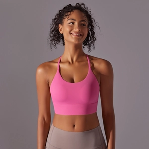 Detail of rose pink halter yoga bra with thin straps and wide elastic support band