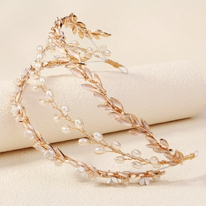Close-up of handmade gold leaf headband with white pearls and delicate floral accents