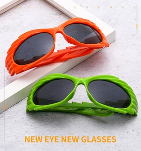 Close-up of avant-garde flame-textured orange and green sunglasses on geometric stands