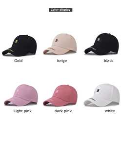 Detail showing various colors of baseball caps with 'B' embroidery and curved brims