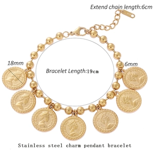 Detail of gold coin bracelet featuring Queen Elizabeth II pendants and ball chain texture