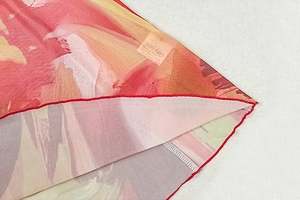 Detailed macro view of colorful printed knit fabric texture and high-quality hem stitching