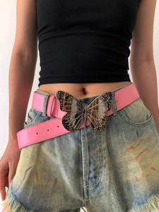 Pink faux leather belt with a silver metal butterfly buckle shown on blue denim shorts