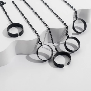 Detail of punk style black metal slave bracelet with adjustable chain rings on white decor