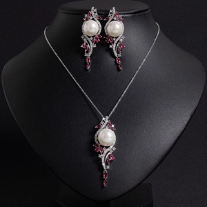 Elegant silver necklace and earrings set with white pearls and pink zircon accents