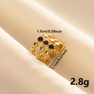 Detail view of gold triple-layer hollow ring with black enamel dots and size dimensions