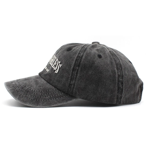 Close-up of distressed washed grey baseball cap with white embroidered 3D letter logo