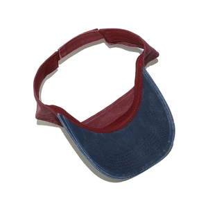 Detailed close-up of retro washed canvas sun visor with navy brim and burgundy band