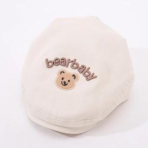 Close-up of bear embroidery and bearbaby text on beige cotton baby beret cap