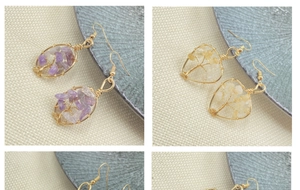 Detail view of handmade wire-wrapped leaf earrings with colorful natural crystal stones
