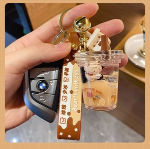 Detail of creative bubble tea keychain with floating bear liquid and brown hand strap