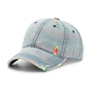 Close-up of distressed light blue denim hat with vibrant colorful stitching details