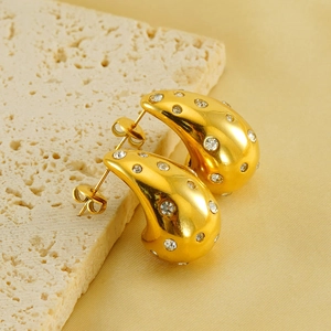 Elegant 18K gold-plated teardrop earrings with sparkling zircons on textured stone base