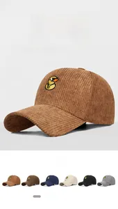 Detailed close-up of corduroy baseball caps with cute embroidered ducks in various colors