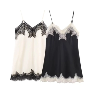 Detail shot of V-neck satin camisole with delicate eyelash lace trim and thin straps