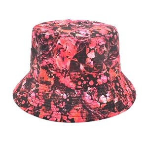 Detail of red and pink tie-dye pattern on a bucket hat with reinforced brim stitching