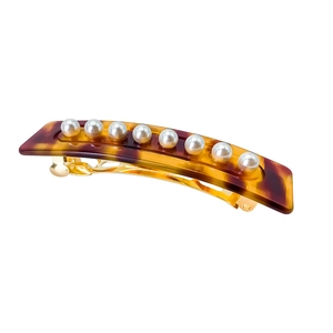Close-up of vintage tortoiseshell acetate hair clip with nine white round pearls