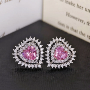 Macro detail of luxury pink heart-shaped stud earrings with double-layered zircon pavé