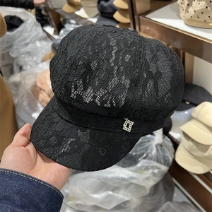 Detail of floral lace mesh and rhinestone buckle on this black baker boy hat